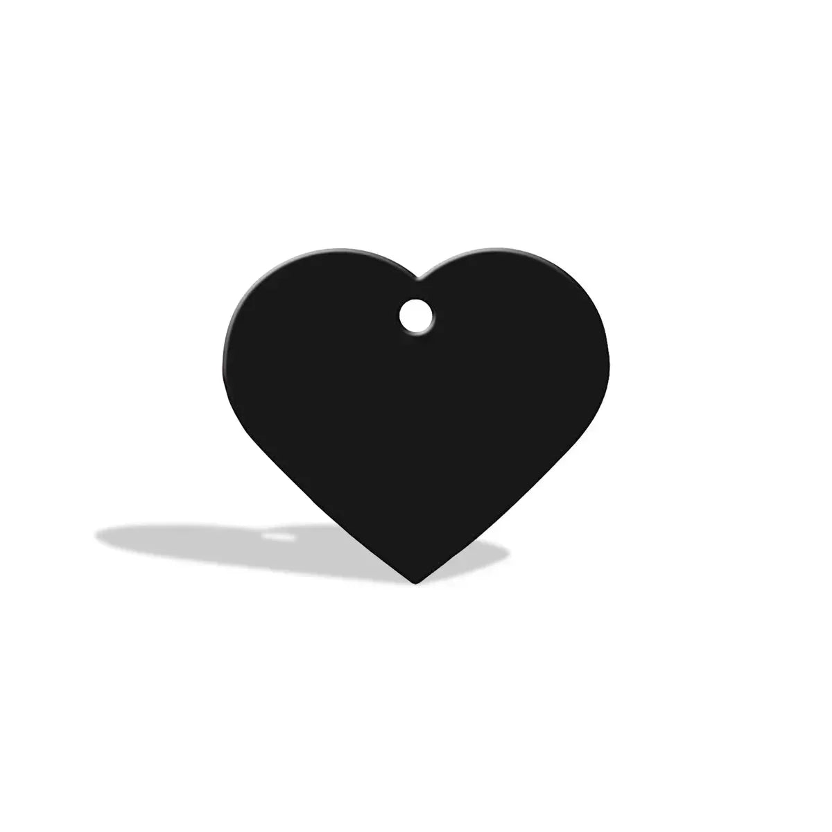 black heart-shaped tag with a hole at the top casting a shadow on white background zigly