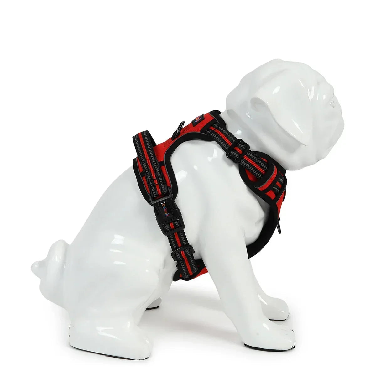 White dog mannequin wearing red and black adjustable pet harness with zigly branding