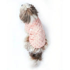 Zigly dog wearing pink textured pet shirt, sitting on white background