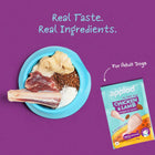 Zigly dog food with real chicken, lamb, and grains in a blue bowl, package for adult dogs