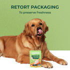 Golden retriever dog licking lips with applod chicken & veggies dog food on white and green background zigly