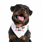 smiling Rottweiler wearing zigly white bandana with HO-HO-HO and red reindeer on white background