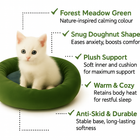 White kitten sitting in green zigly snug doughnut-shaped plush pet bed with anti-skid base