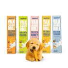 Golden puppy chewing Applod Yak and Roll dog chew with five colorful boxes in background zigly