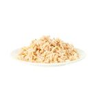Zigly shredded chicken wet pet food on a white plate, isolated on white background