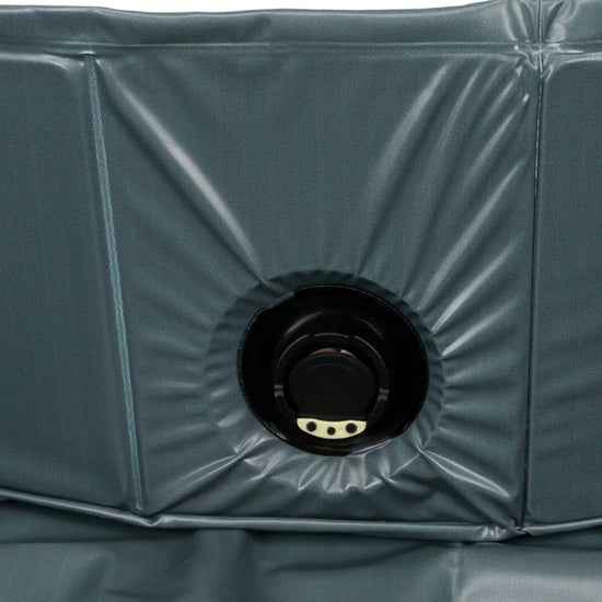 Close-up of black plastic valve on dark grey inflatable material, zigly