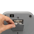 Hand opening battery compartment of gray electronic device with on/off switch, zigly