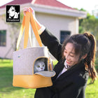 Woman holding a zigly Truelove stylish cat carrier bag with a white cat inside outdoors
