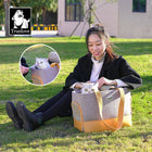 Woman sitting on grass petting a cat in a textured pet carrier bag with beige straps, branded Truelove, zigly