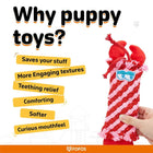 Hand holding red and pink woven puppy toy with blue eyes patch, text listing benefits in yellow and black, zigly
