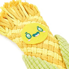 Zigly woven yellow and green plush corn toy with a smiling embroidered face on white background
