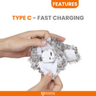 Hands holding a fuzzy gray and white plush toy showing built-in Type C charging port for fast charging by Zigly