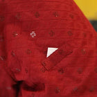 zigly red embroidered fabric with geometric cutout pattern and a pocket detail