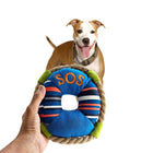 Zigly pet toy SOS lifebuoy held in hand with happy brown and white dog wearing camouflage collar