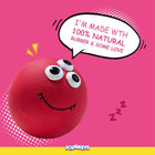 Red squeezzy ball with googly eyes and smile on pink background saying made with 100% natural rubber zigly