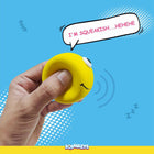 Hand squeezing yellow smiley face stress ball toy with speech bubble saying I'm squeakish, zigly