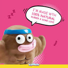 Zigly Squeezys brown cartoon toy with muscles and blue headband, speech bubble says 100% natural rubber