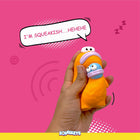 Hand squeezing orange and blue cartoon squeeze toy on pink background with text I'm squeakish hehehe and zigly