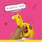 Hand holding yellow squeaky giraffe toy on pink background with speech bubble I'm squeakish Hehehe zigly