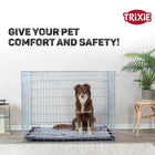 Brown dog sitting inside open wire crate on gray mat with Trixie logo, zigly comfort and safety