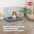 Zigly Trixie metal dog crate with Shetland Sheepdog inside, indoor setting with plant and pouf