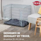 Zigly metal dog crate with dark cushion in modern living room near gray armchair