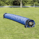 German shepherd dog exiting blue agility tunnel on green grass outdoors zigly