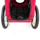 Zigly red pet stroller with black interior padded seat and safety leash clip on white background
