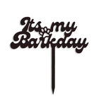 Black cake topper with cursive text 'It's my Barkday' and a paw print, zigly design